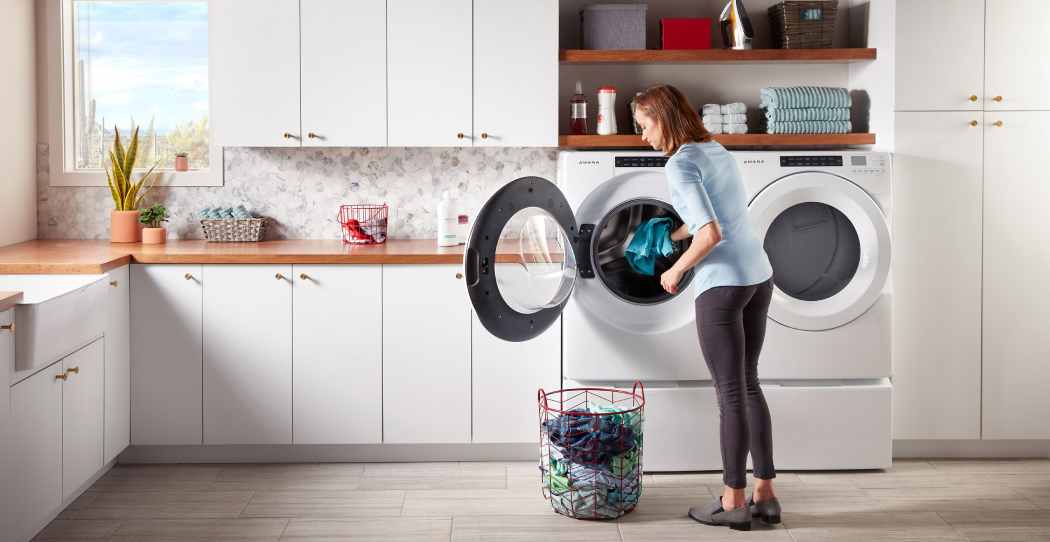 a woman loading a washing machine